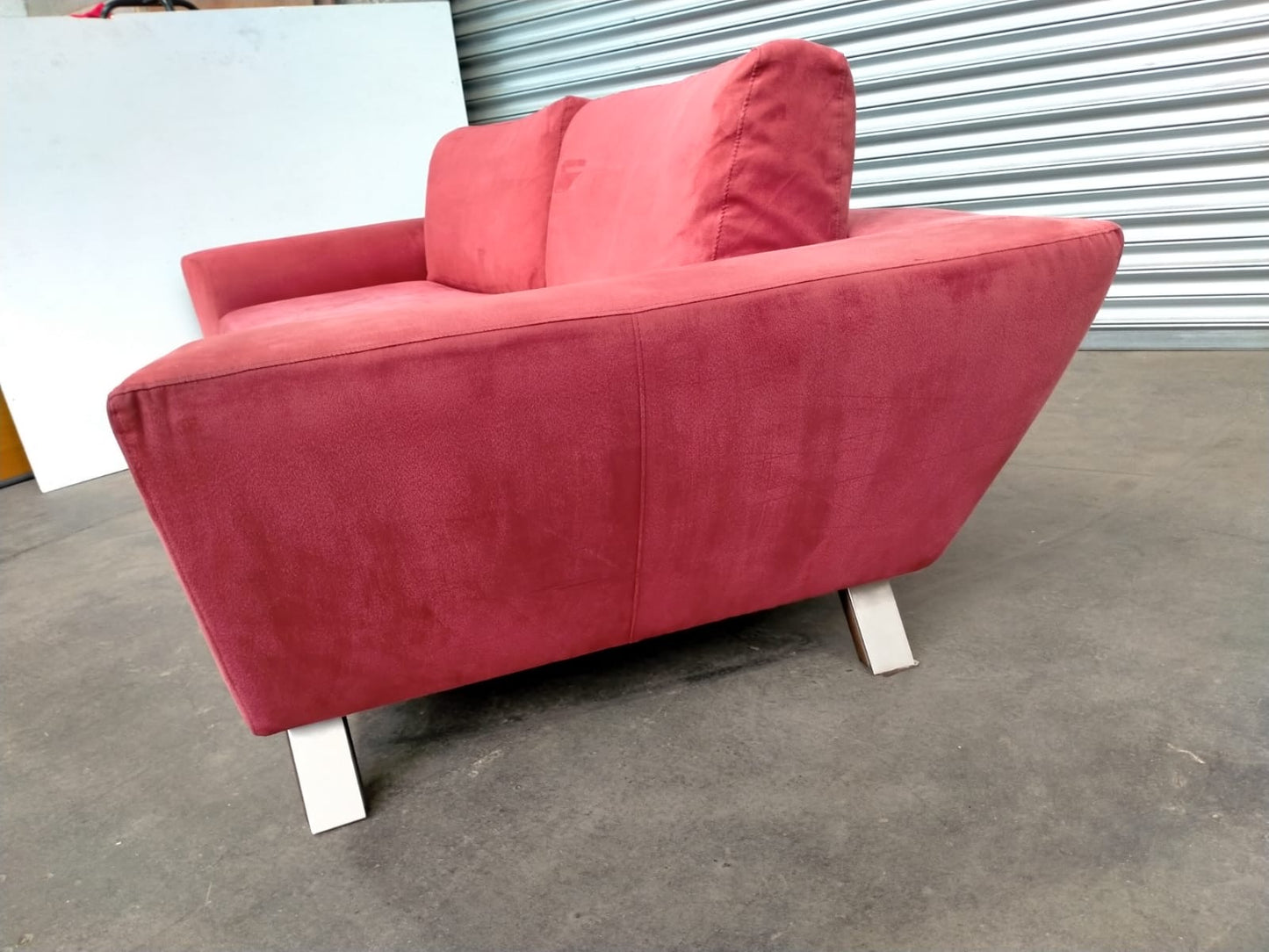 Indulge in Luxury and Style with NATUZZI's Elegant Red Fabric Sofa.
